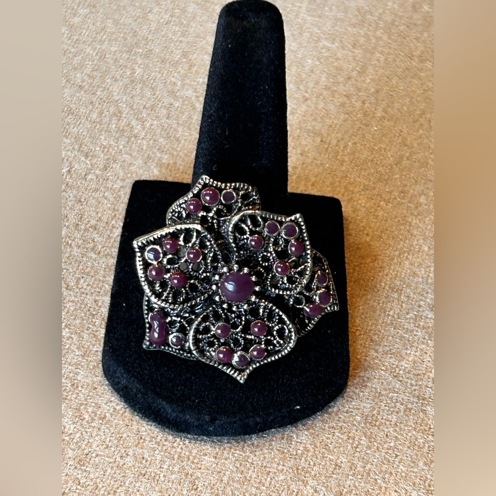 Vintage bohemian style ring in floral shape with solid purple stones. Adjustable